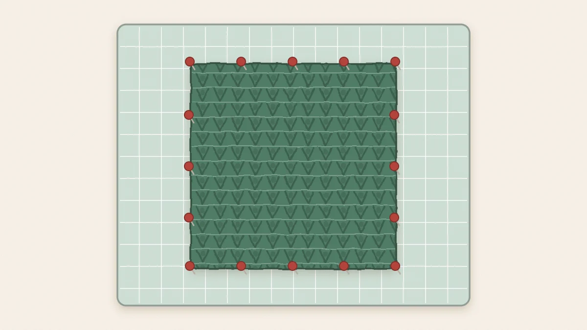 A square crochet piece pinned out on a grid blocking mat, with pins at each corner and evenly spaced along all four edges