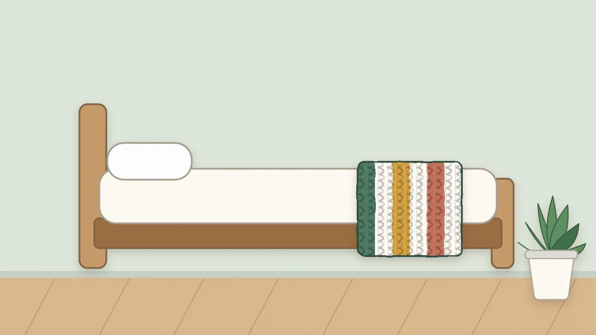 Bed seen from the side with a wide-striped crochet runner laid across its foot