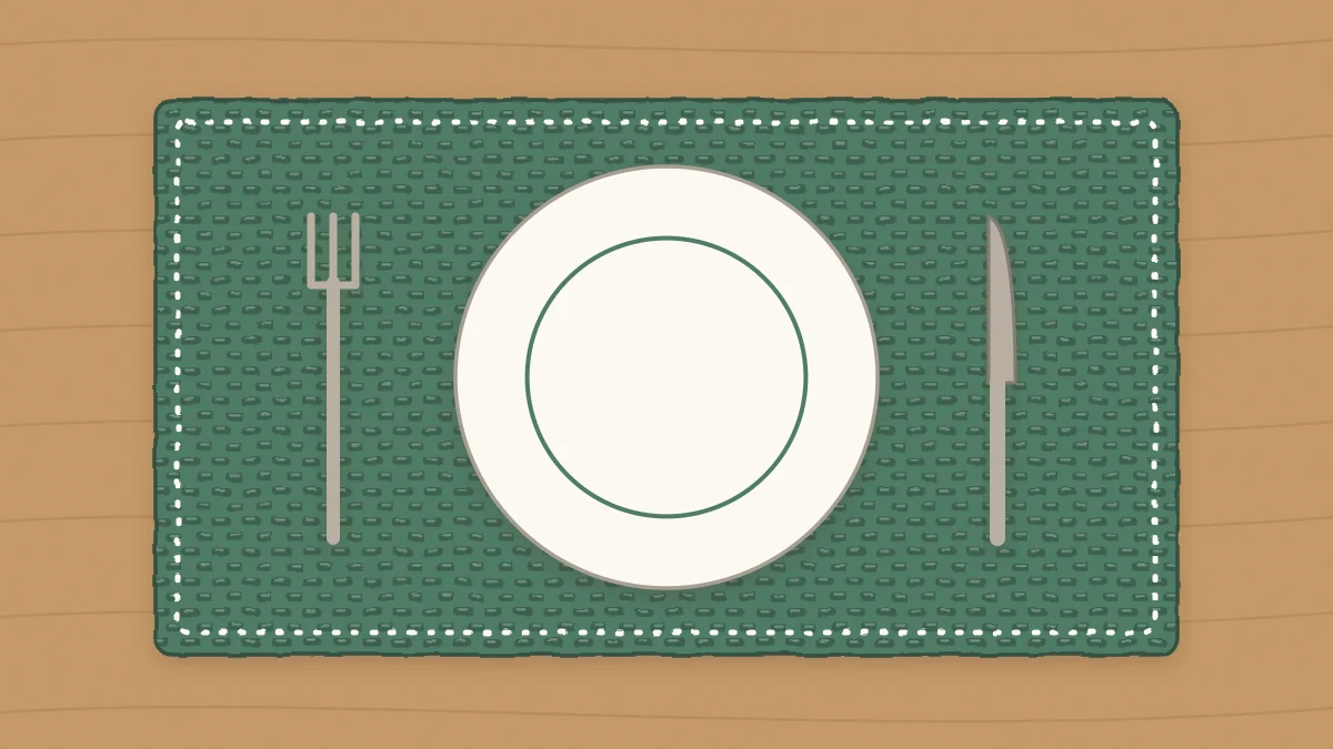 A rectangular crochet placemat with a plate, fork and knife on it
