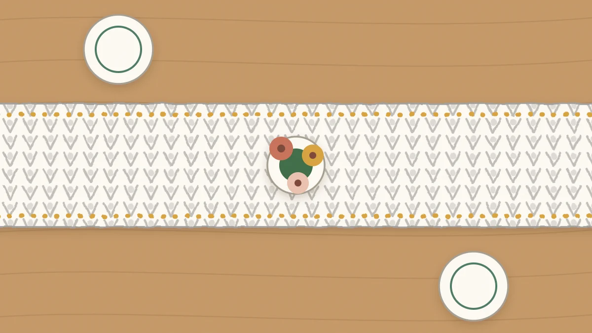 A long crochet table runner down the center of a table with a vase on it